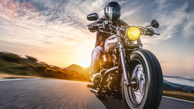 motorcycle rider going down the road 